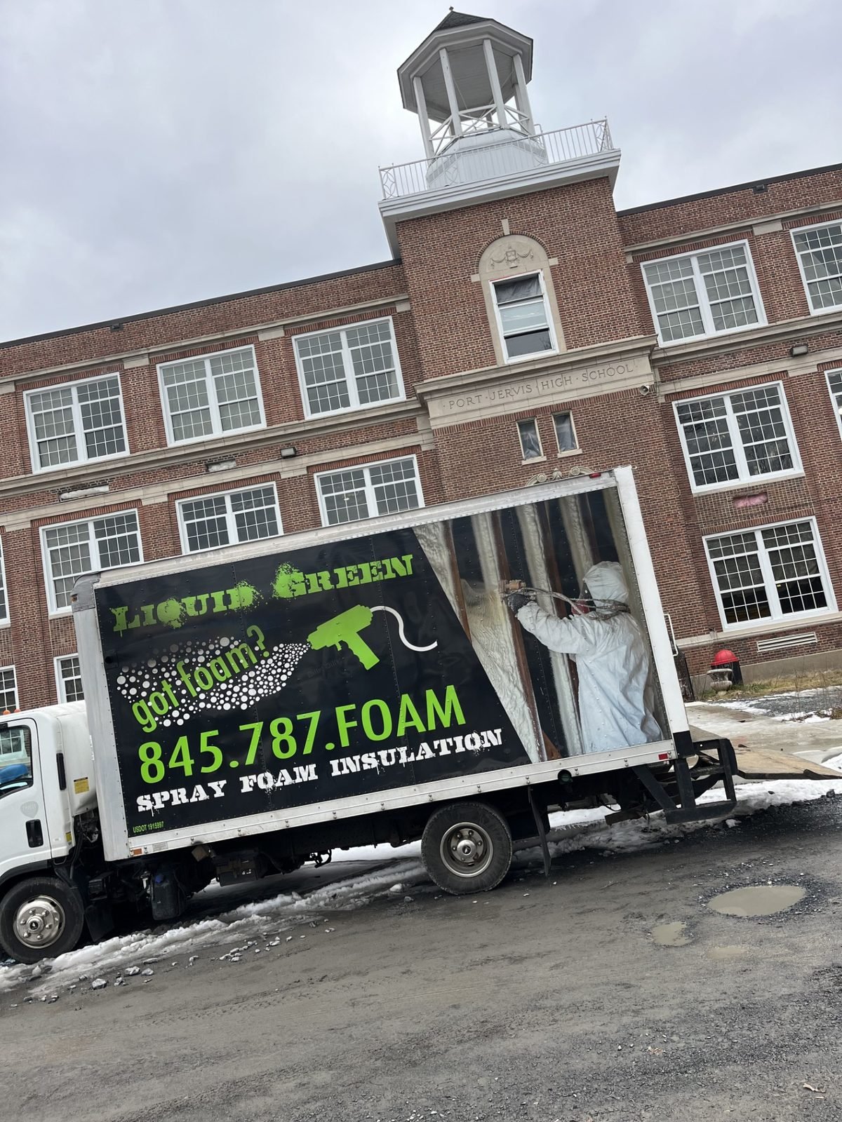 Liquid Green mobile spray foam rig — the equipment behind the work.